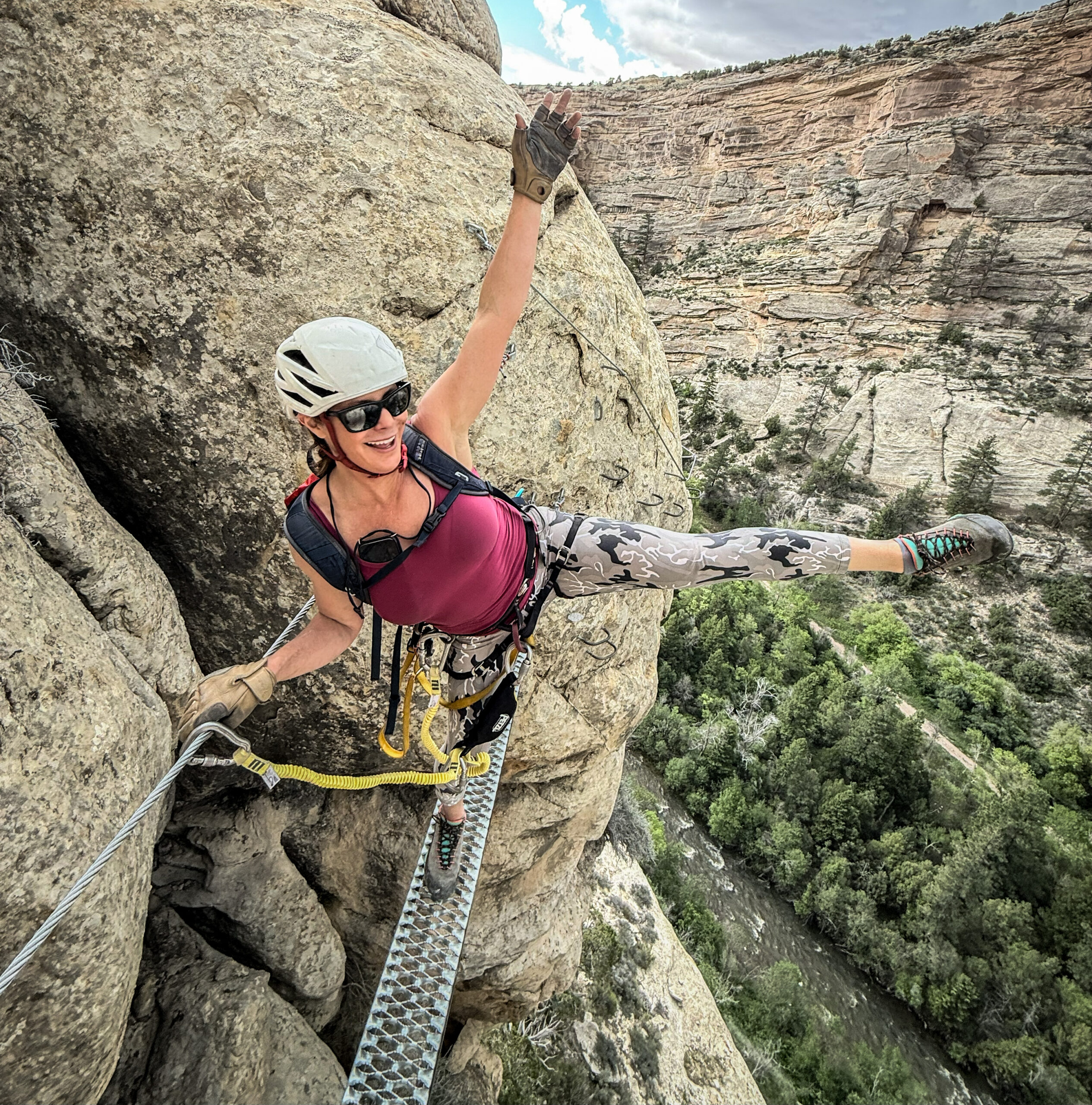 Climber on a via ferrata bridge